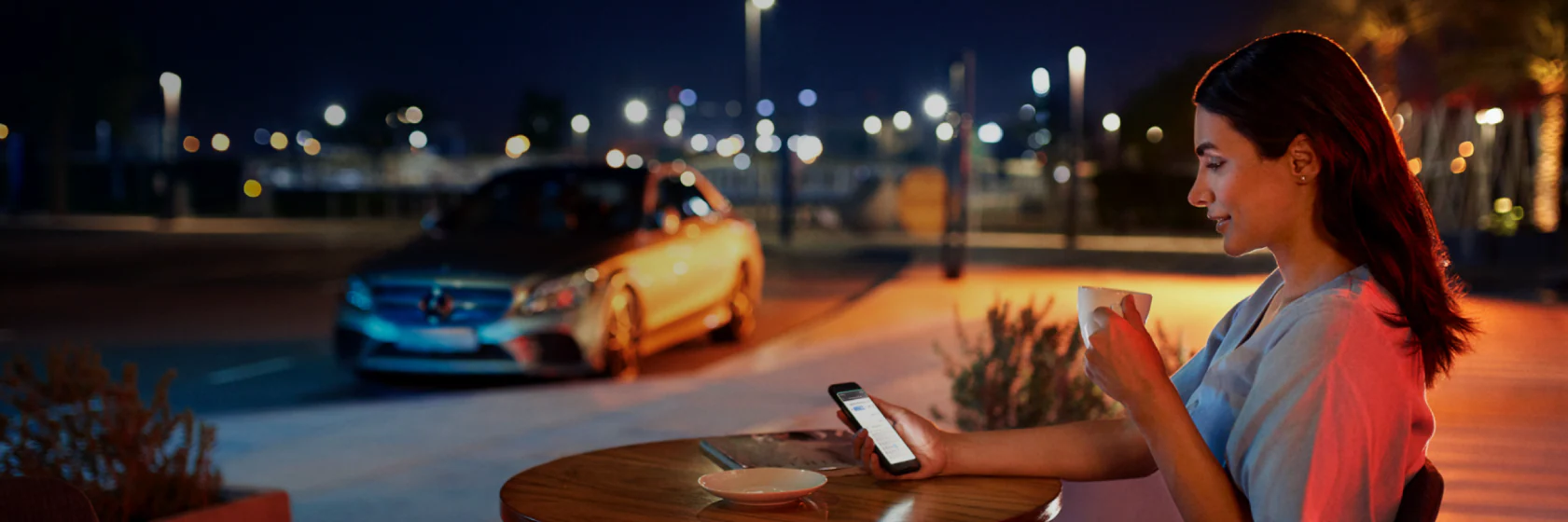 Woman sat at table on her phone