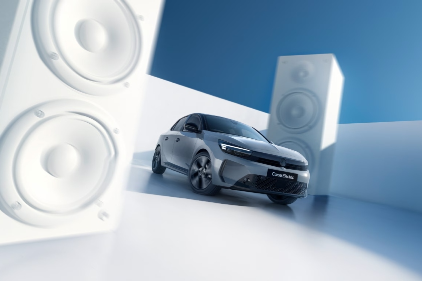 New Corsa Electric next to white speakers