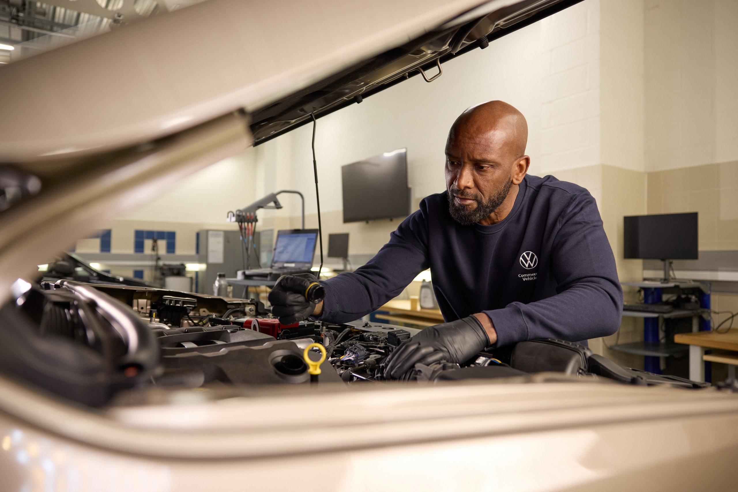 Volkswagen Mechanic Inspecting Engine