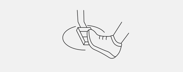 Black and white outline icon of foot on a pedal