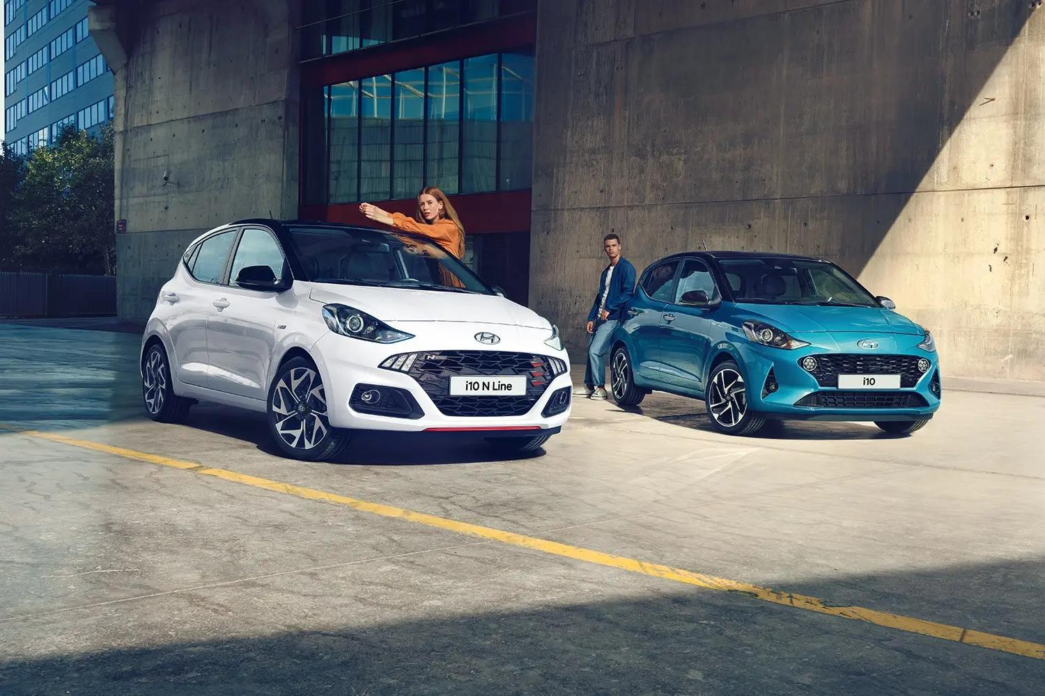 A white and a blue Hyundai parked together