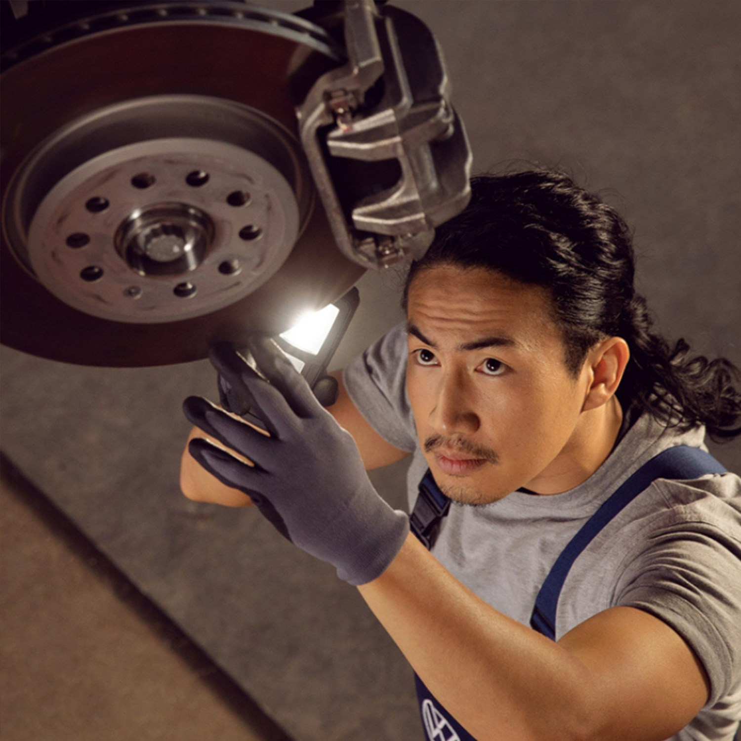 Mechanic inspecting brake disc