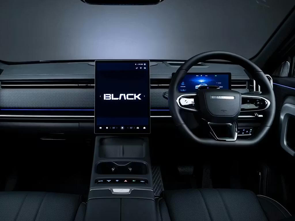 Interior cockpit view of the Jaecoo 7 Black edition, featuring a portrait-oriented central touchscreen, digital instrument cluster, leather-wrapped steering wheel and ambient lighting accents.