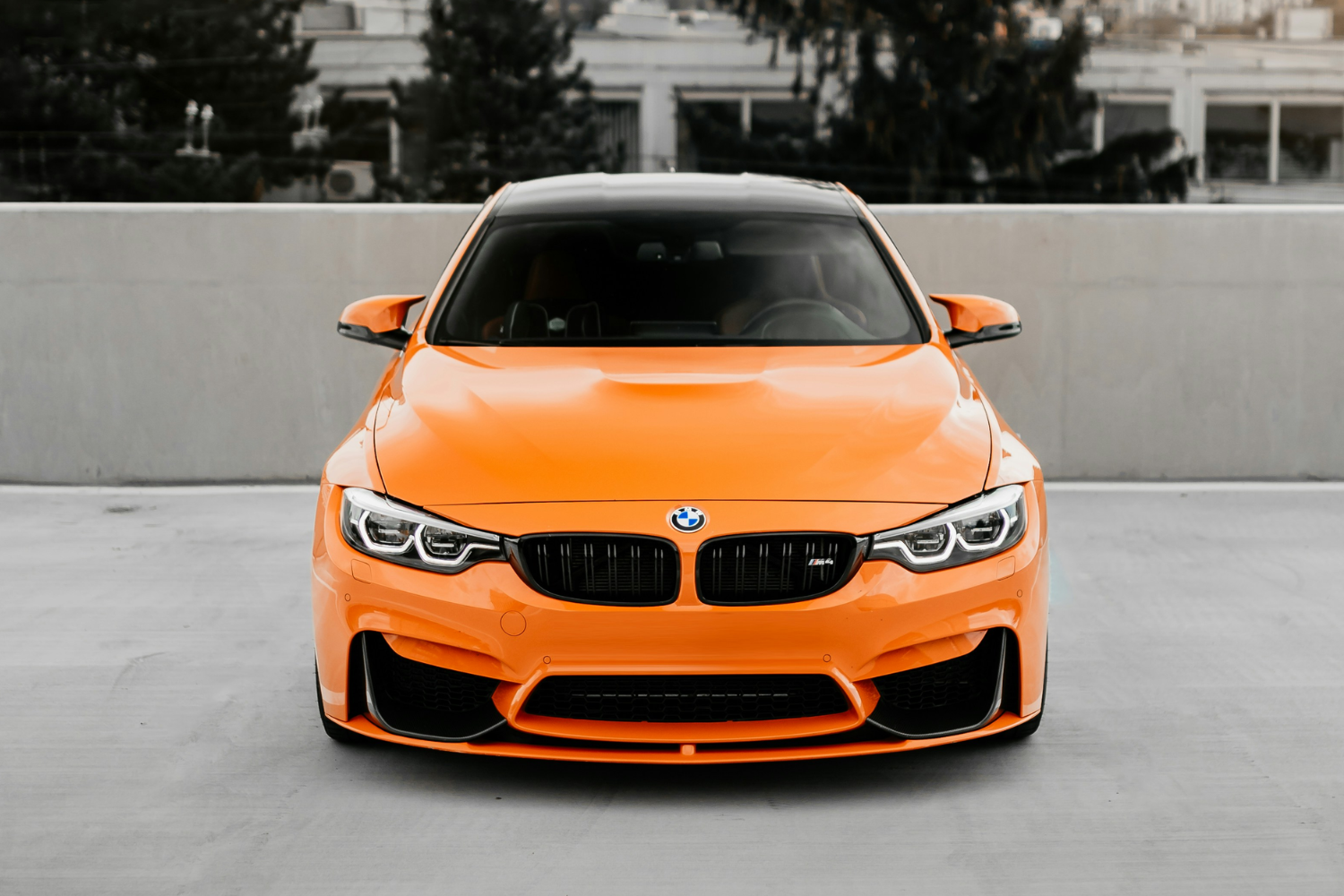 Front view of orange BMW performance coupe.