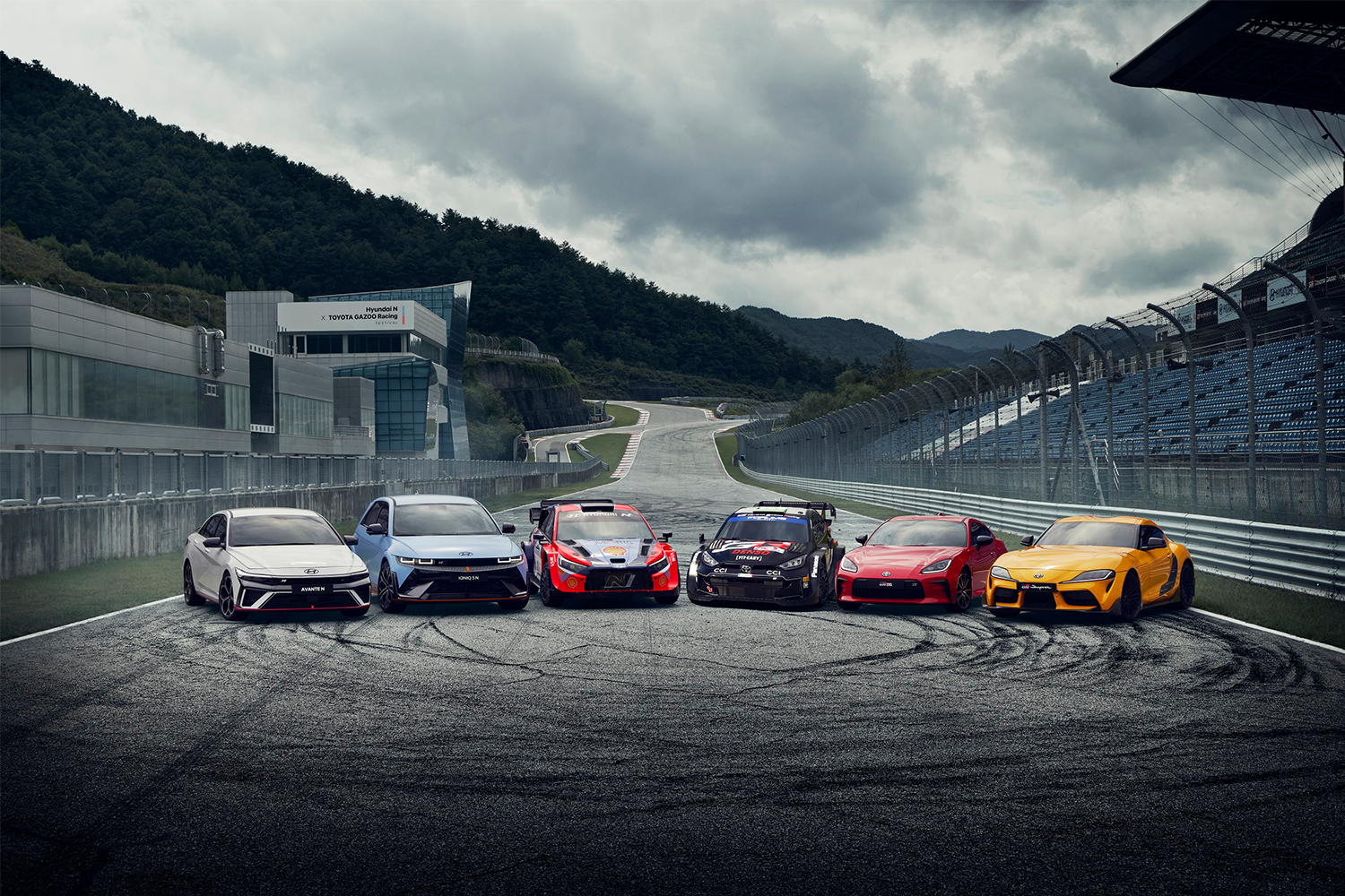 Cars Lined up next to each other on a race track