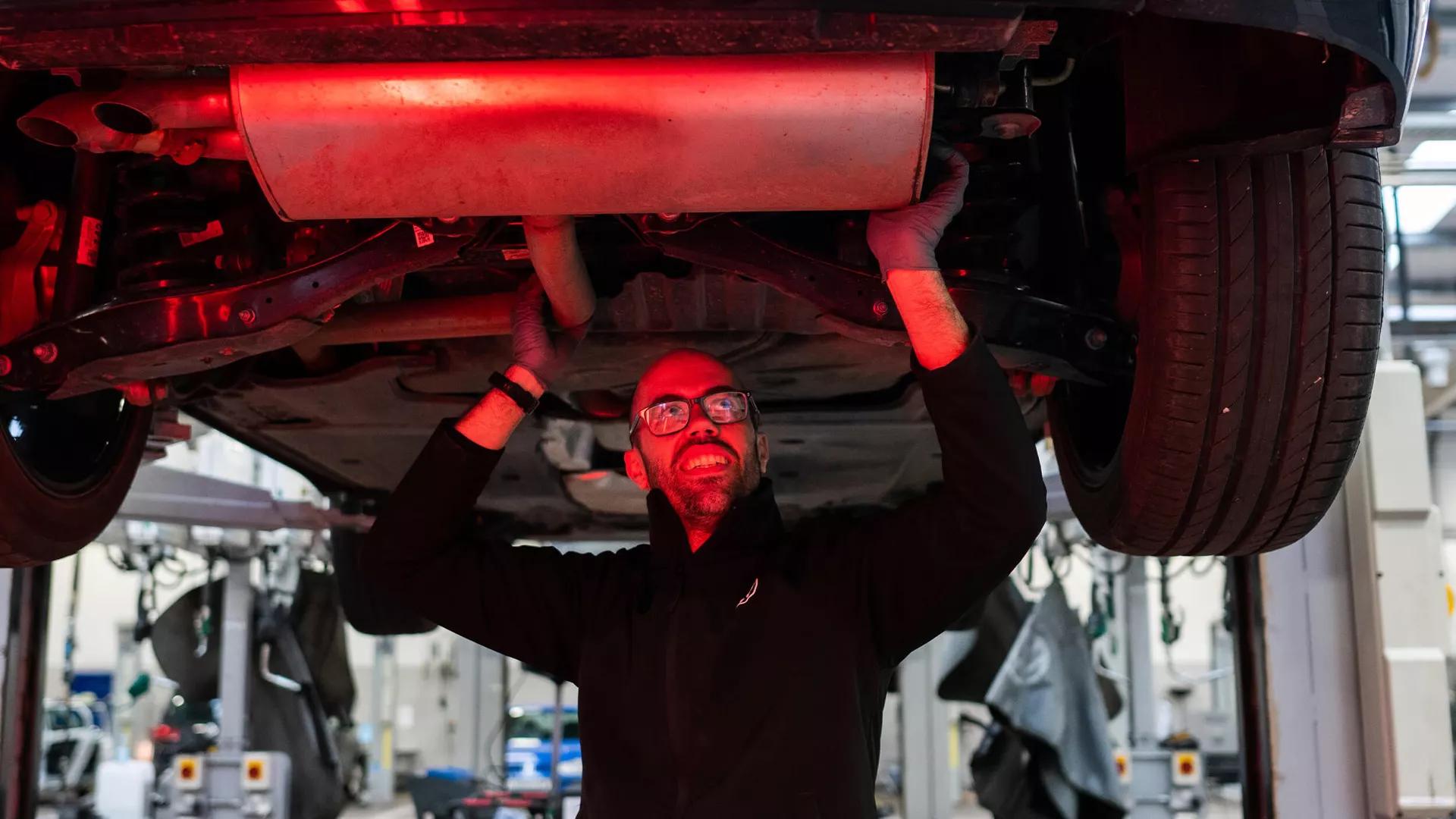 Mechanic working underneath a vehicle