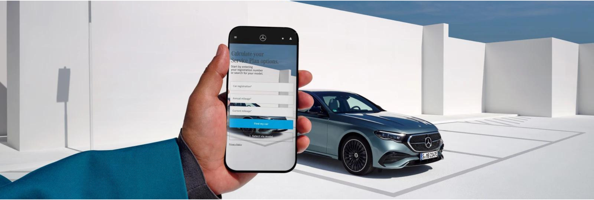 Mercedes-Benz App on Smartphone in front of Mercedes-Benz Vehicle