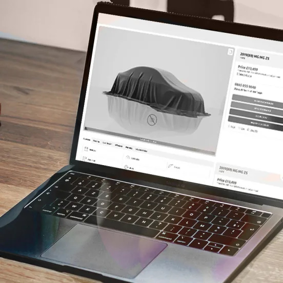 up close of laptop with a car undercover image