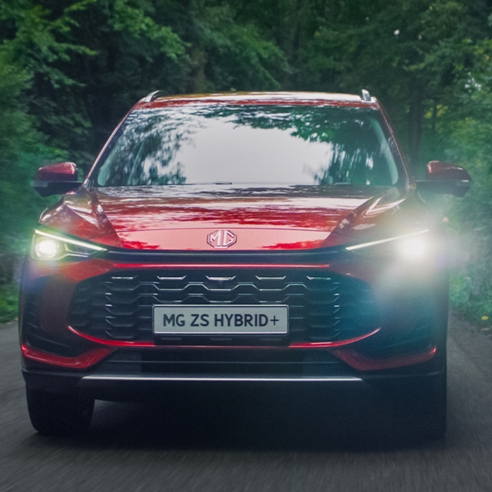 Red MGZS Driving In A Forest Road