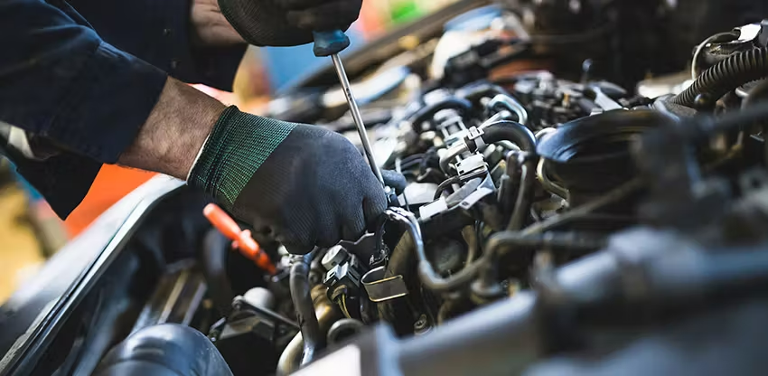 Mechanic Working On Car Engine
