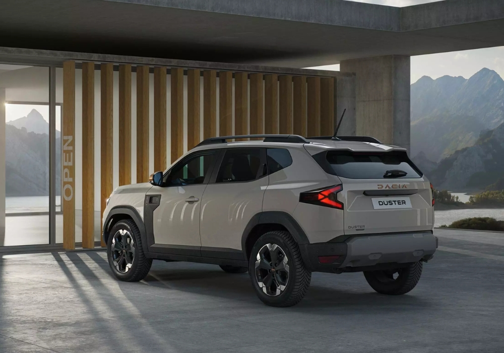 Dacia Duster parked outside a modern building, showcasing robust design and elevated stance in an architectural setting.