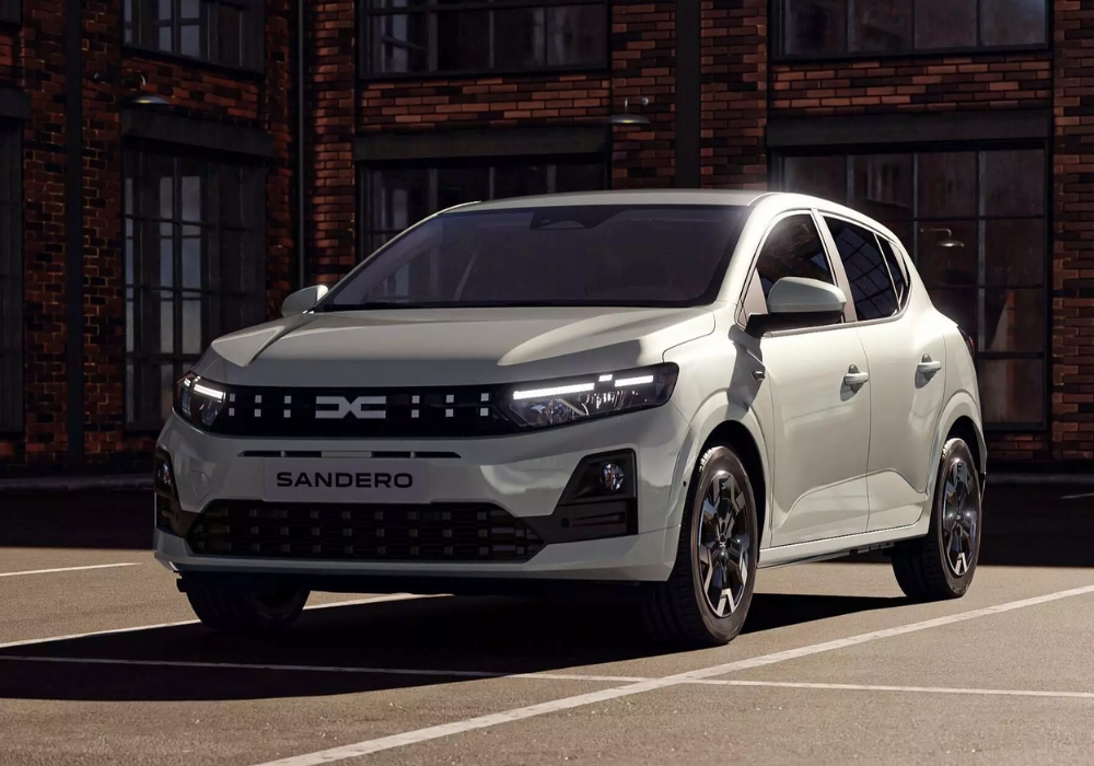 Dacia Sandero parked in an urban setting with brick buildings, highlighting modern front design and compact proportions.