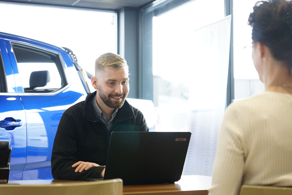Man smiling infront of laptop