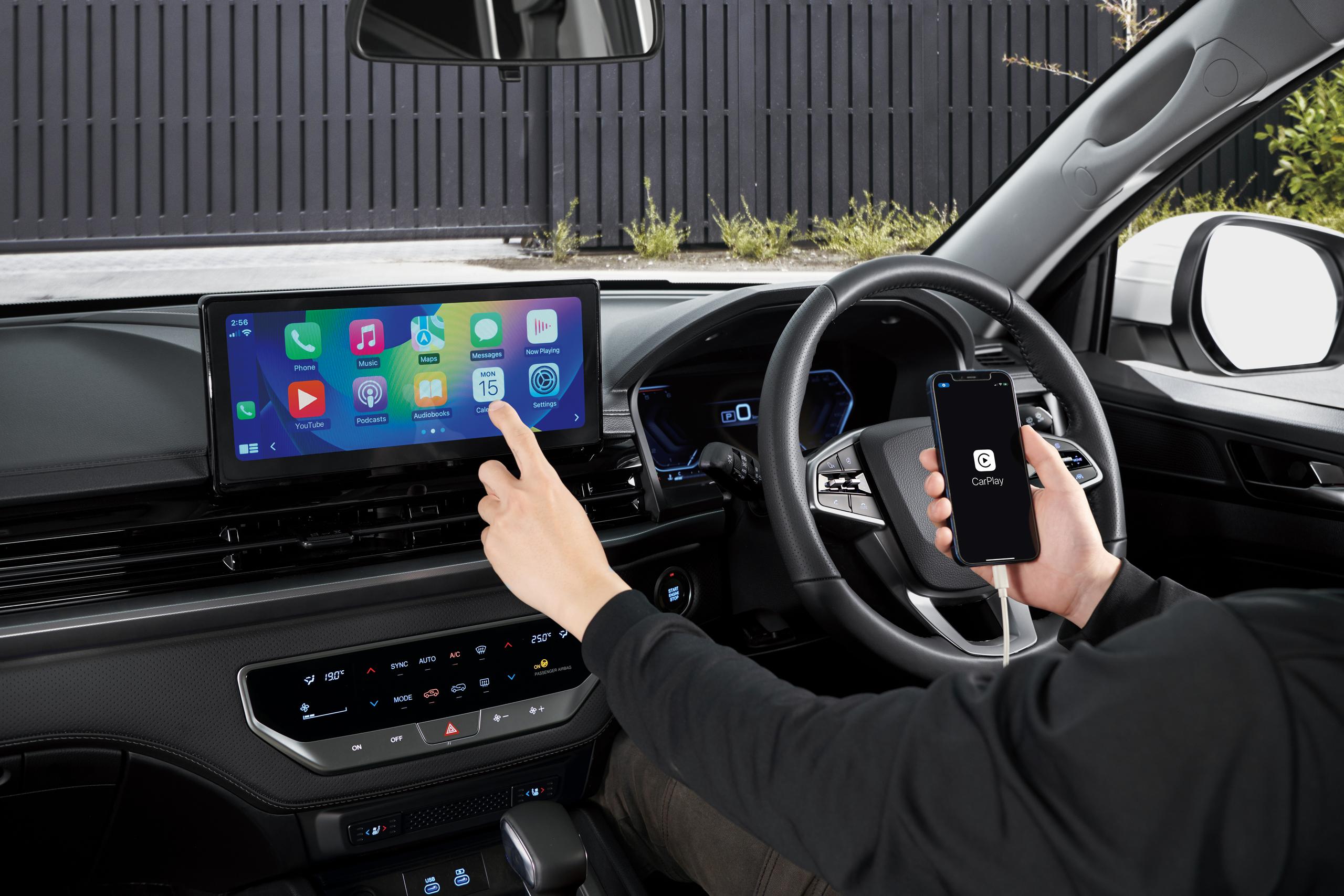 KGM Musso infotainment tech- someone using apple carplay in pickup