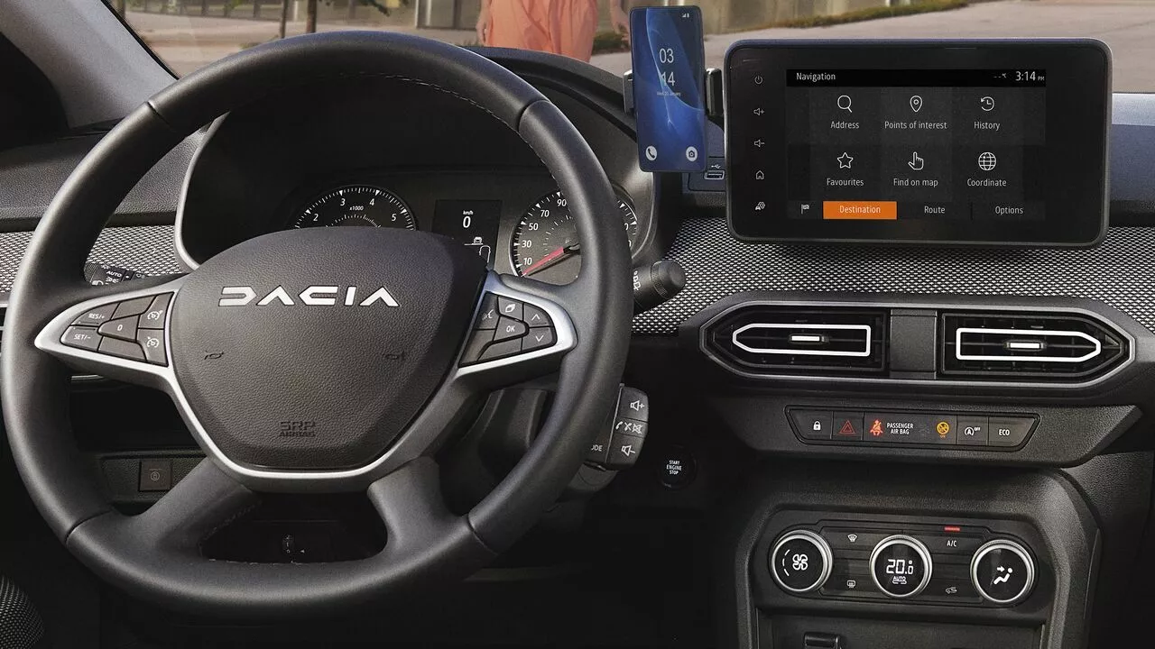 Interior of the Dacia Sandero Stepway showing the steering wheel, instrument cluster, and touchscreen.