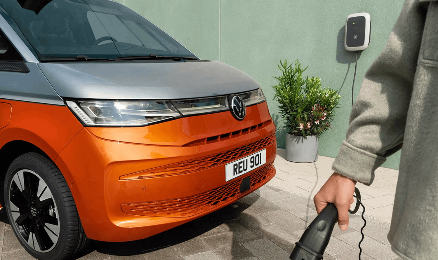 Orange and White New Volkswagen Multivan being put on charge