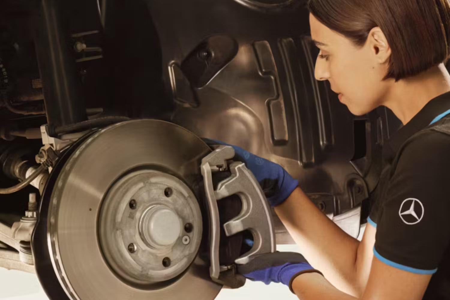 Mercedes-Benz Mechanic Working On Brake Disc