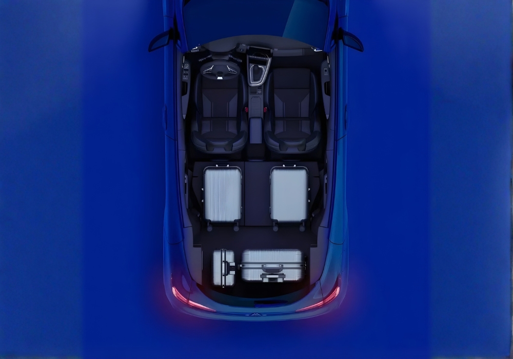 Top-down view of Renault Clio showing boot space with luggage and folded rear seats.