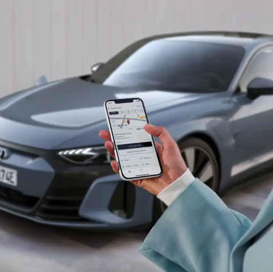 Person on myAudi App with Audi in the background