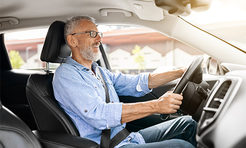 Older man driving car side view