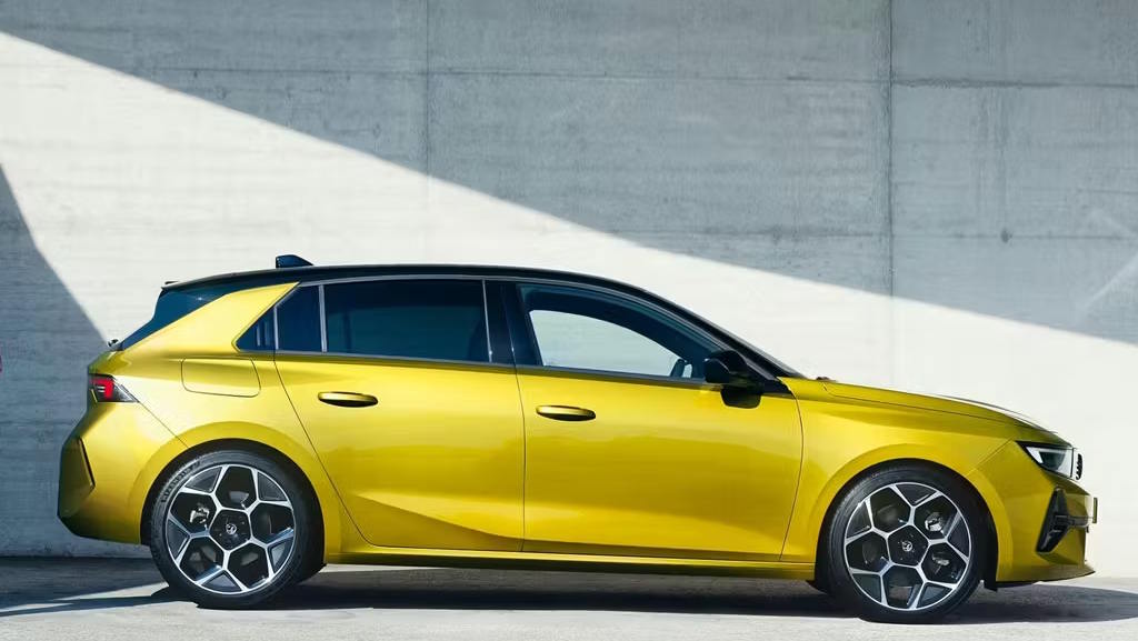 Yellow Vauxhall Astra showcased in side profile highlighting its sleek hatchback design.
