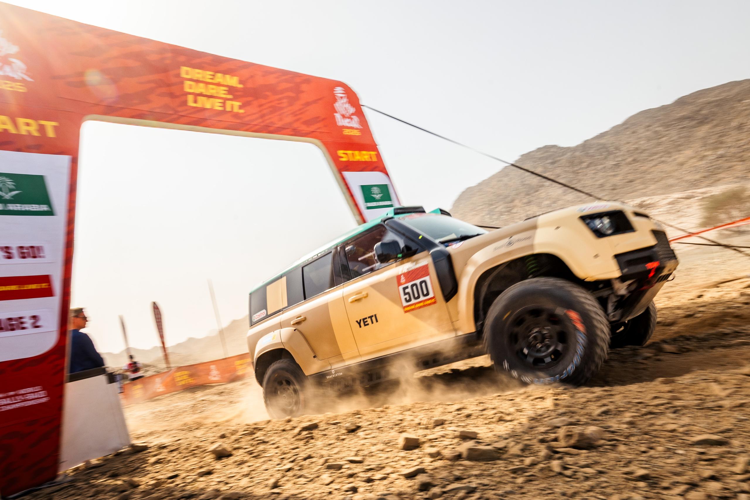 side view of Land Rover Defender at the starting line in a rally 