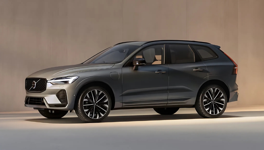 Volvo XC60 in grey parked beside a modern wall.