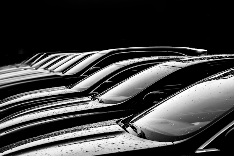 Cars in a row in black and white.