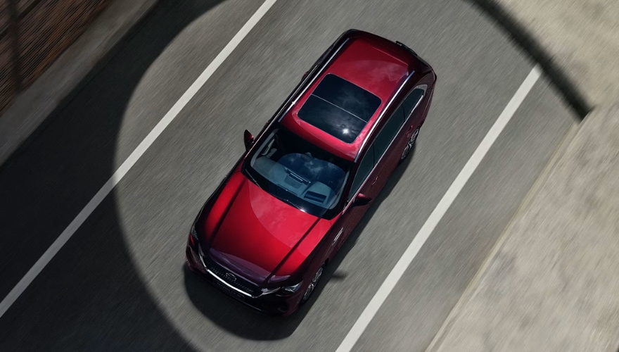 Mazda CX-80 driving in an urban road top exterior view