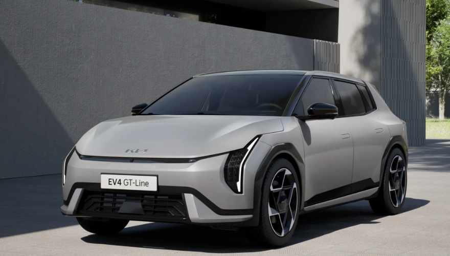 Kia EV4 in grey parked outside a modern building