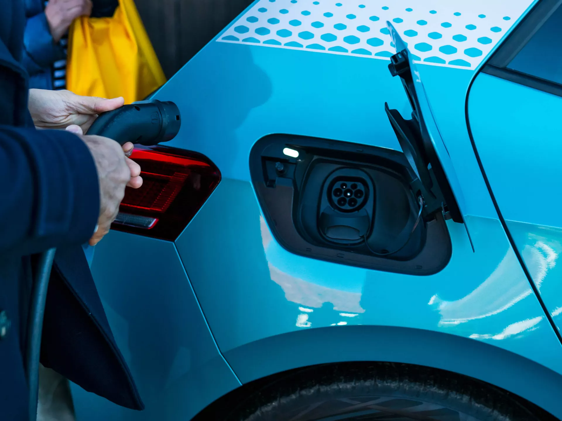 Blue Volkswagen ID3 Charge Socket, person about to insert charging lead
