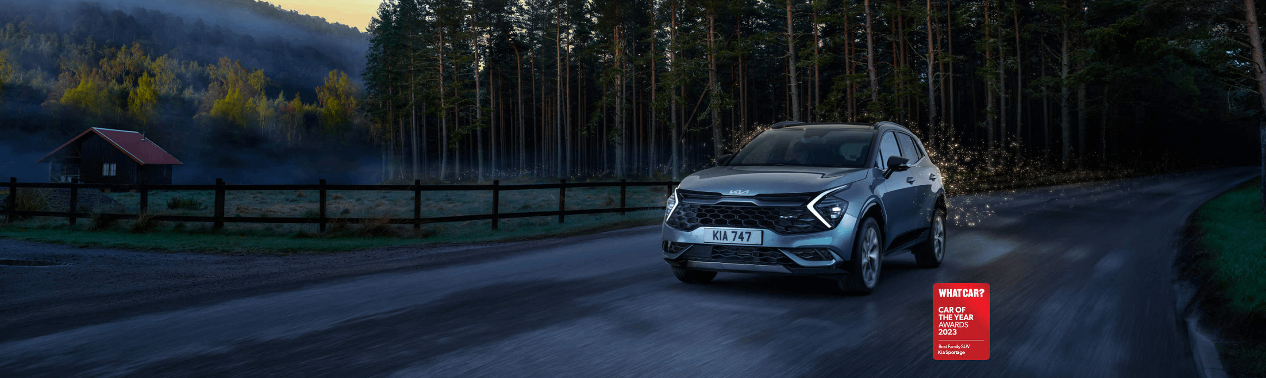 Sportage driving in a dark forest