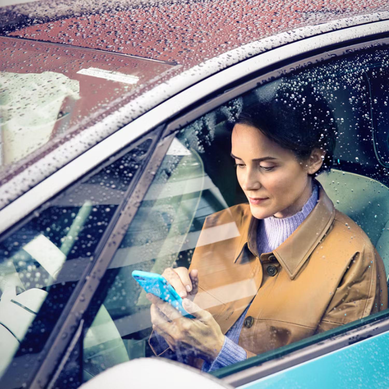 Person on phone sat in vehicle