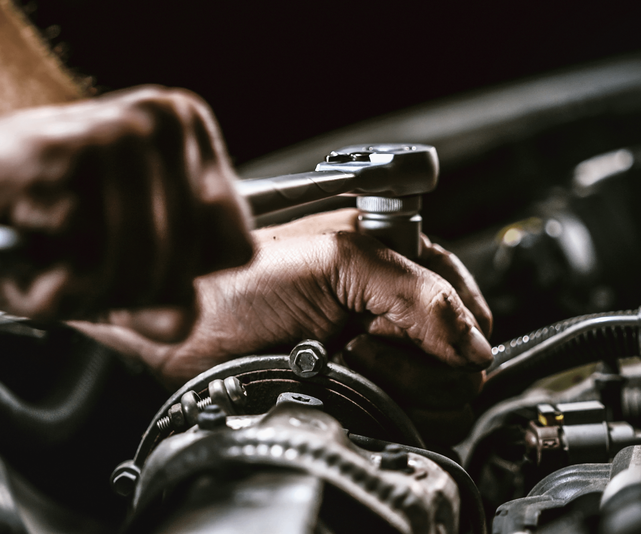 person fixing car