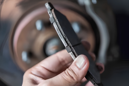 Close-up of a brake pad checked for wear during routine maintenance.
