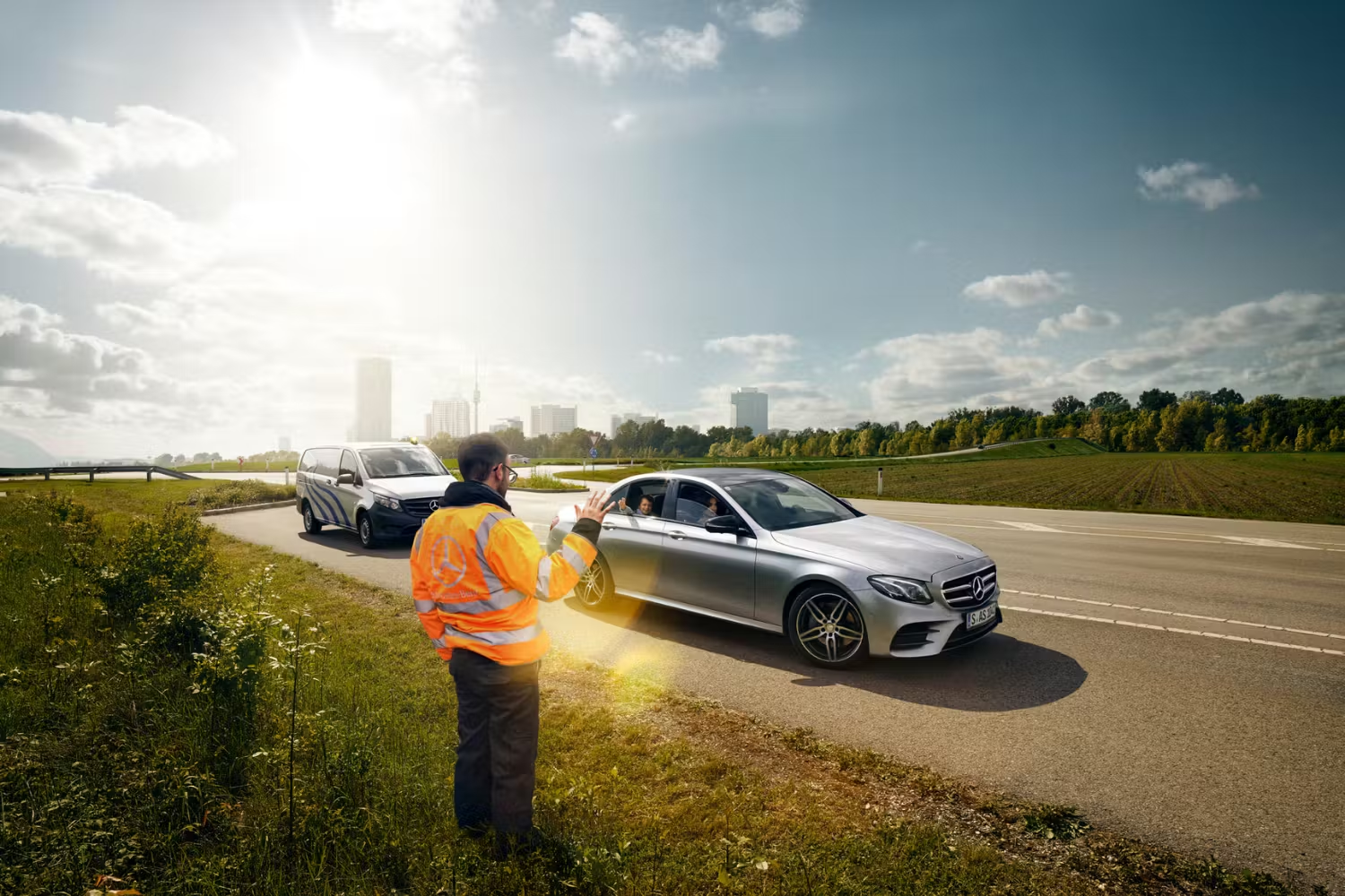 Person high visibility waving away person in Silver Mercedes-Benz