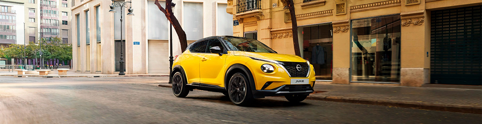 Yellow Nissan Juke in city - banner image 