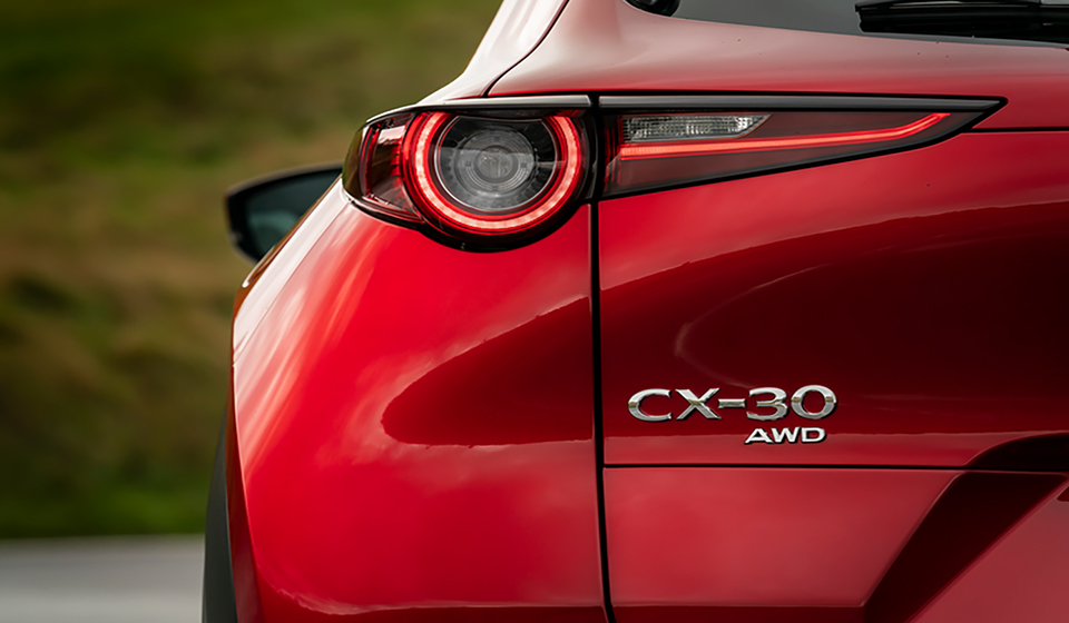Silver mazda cx-30 logo on a red vehicle.