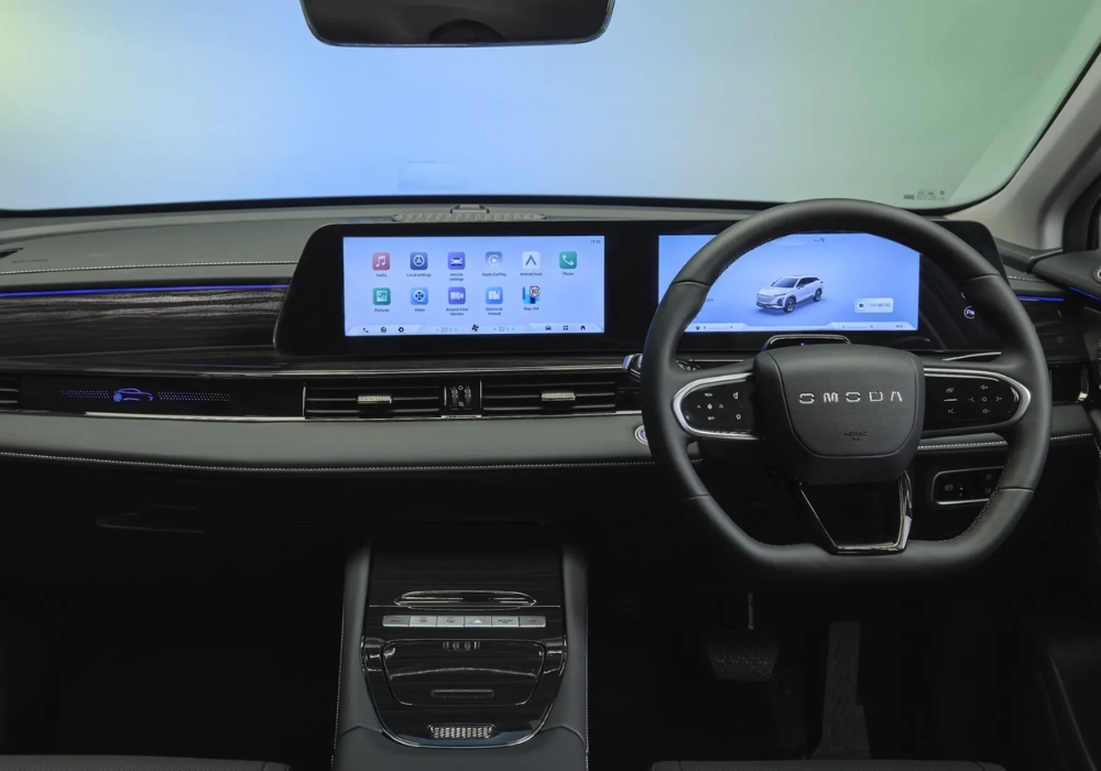 OMODA E5 interior cockpit featuring dual digital displays, minimalist dashboard, and steering wheel with integrated controls.