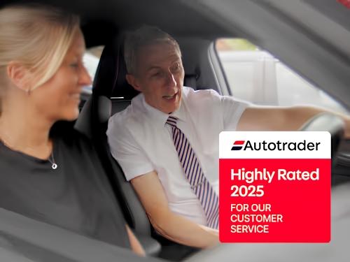Customer receiving a vehicle demonstration from a highly rated dealership sales advisor.