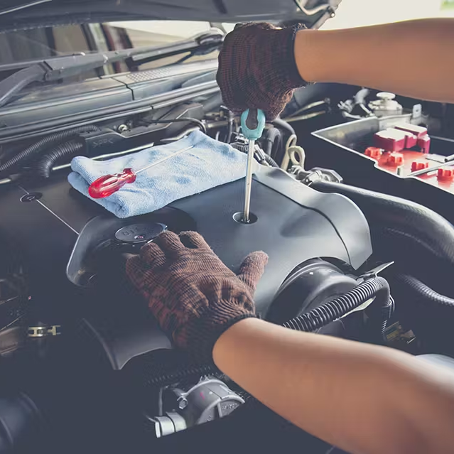 A mechanic fixing an engine