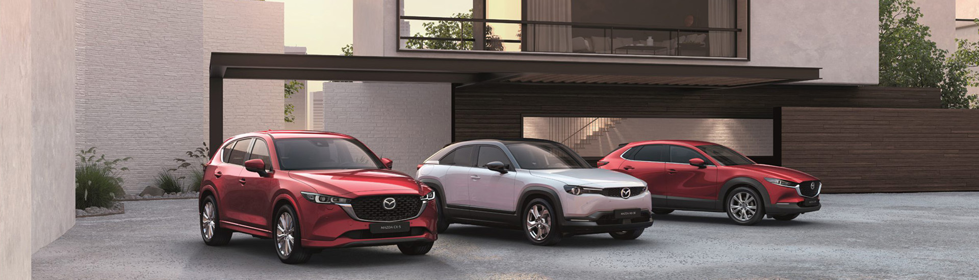 Mazda family SUVs parked outside home
