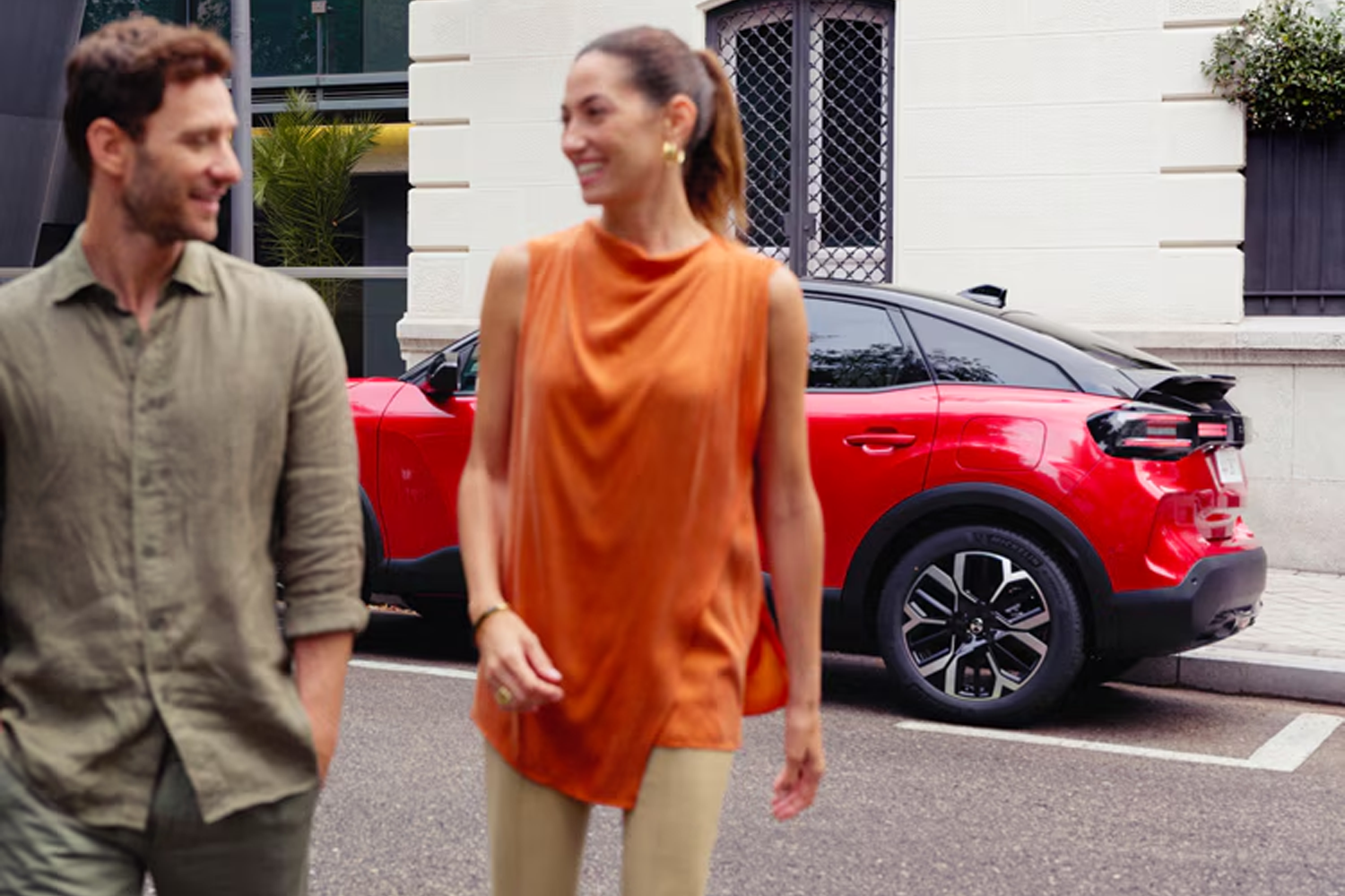 two people chatting in front of a red New C4
