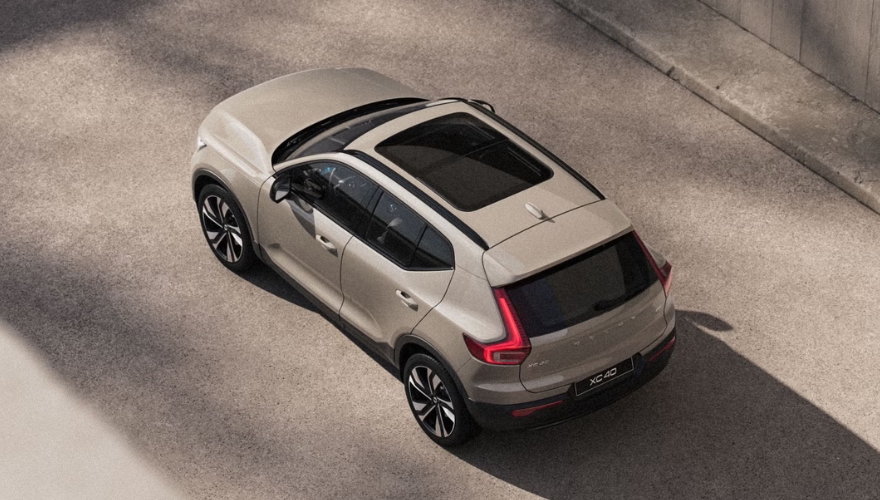 Tan Volvo XC40 photographed from a top exterior view in an urban setting.