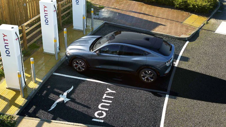 Ionity charging station with a silver car parked in one of the slots.