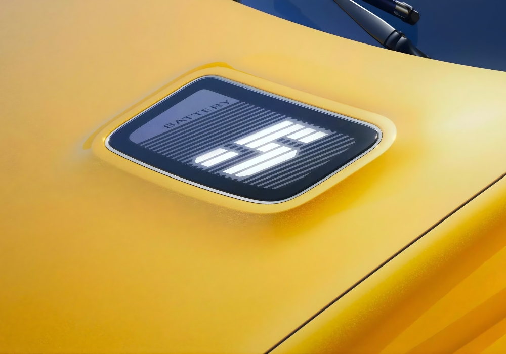 Close-up of Renault 5 E-Tech bonnet display showing battery level indicator.