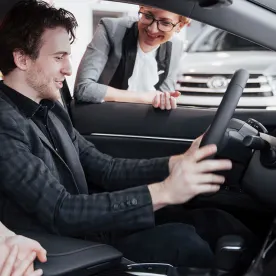 man looking at car interior