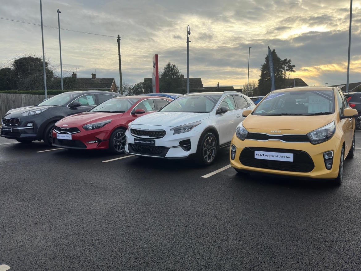 Selection of Kia Approved Used vehicles displayed at a dealership showcasing a range of quality-assured models.