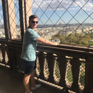 Visitor enjoying panoramic city views from a landmark observation deck.