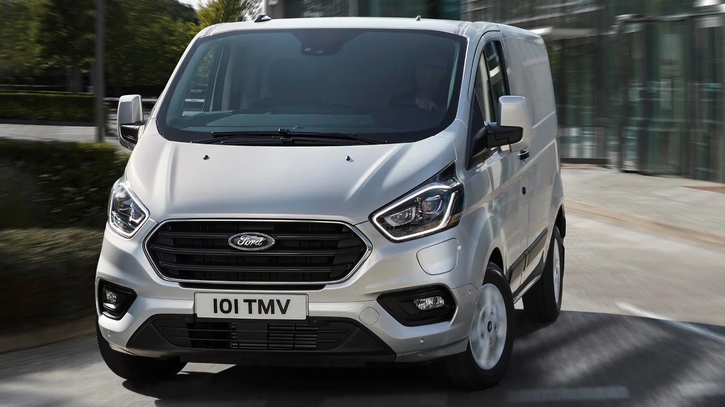 Silver Ford Transit Custom driving along road